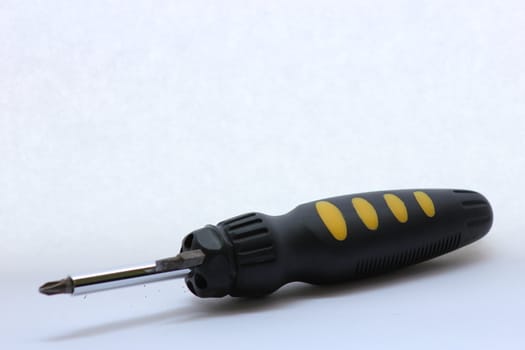 black and yellow screwdriver with extra bit.
