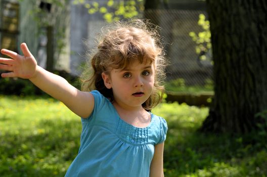 The photo shows a scared little girl telling gesture - do not go.