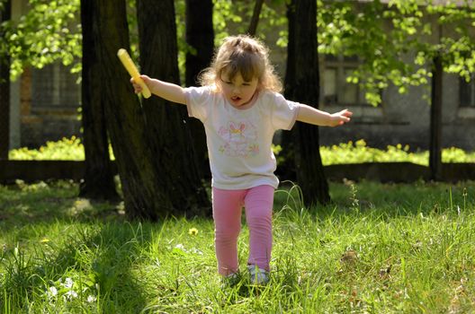 The photo shows a Little girl pretending to be a bird.