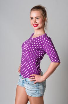 Pin up girl standing and smiling portrait, studio shot
