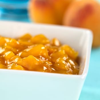 Bowl full of fresh peach compote (Selective Focus, Focus one third into the compote) 
