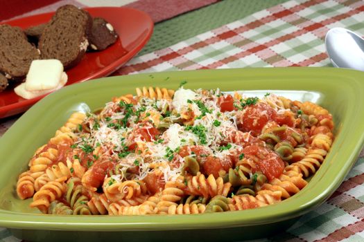 Delicious and perfect made to perfection rainbow rotelli pasta with parmesan cheese and exquisite  fresh organic tomatoes sauce vegans or vegetarians will love it 