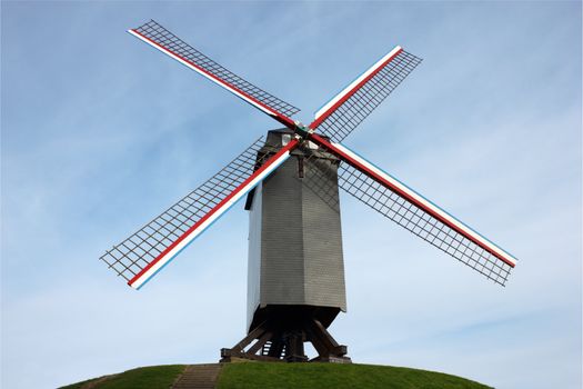 Windmill in Bruges, Belgium shot on blue sky background.