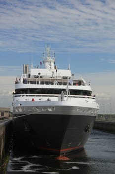 Small cruise ship entering locks on its journey to the sea