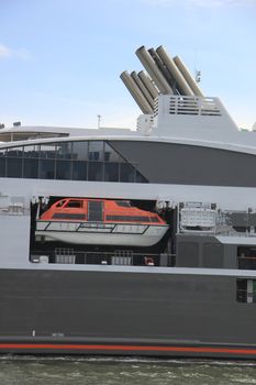 Detail of an orange and white rescue boat on a small cruise ship