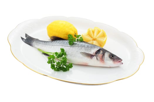 fresh sea bass with lemon and parsley on tray trimmed and isolated