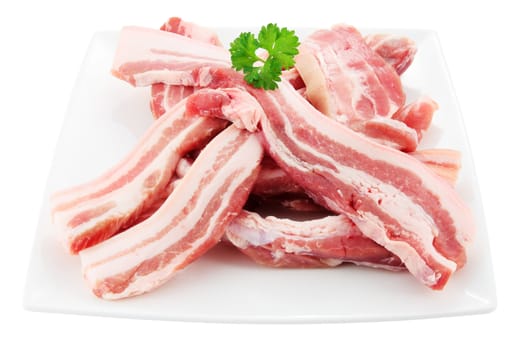 dish of raw bacon cut into fillets with parsley cut off and isolated