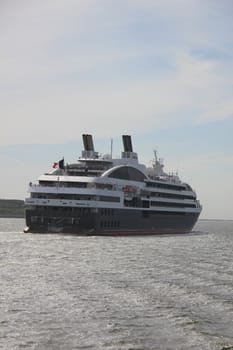 Small cruise ship sailing towards the sea