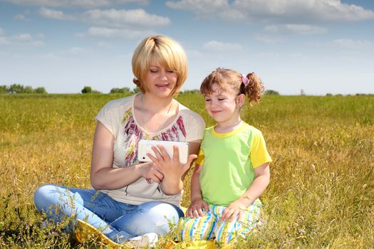 mother and daughter playing with tablet