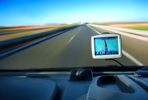 Close up image of gps in a car and road
