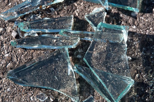 Soil covered with pieces of broken glass