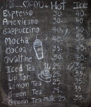 menu in front of coffee, chalk on black board: coffee, espresso, cappuccino