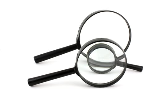 Three old magnifiers over white