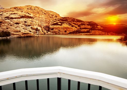 Sunset landscape with lake and mountains