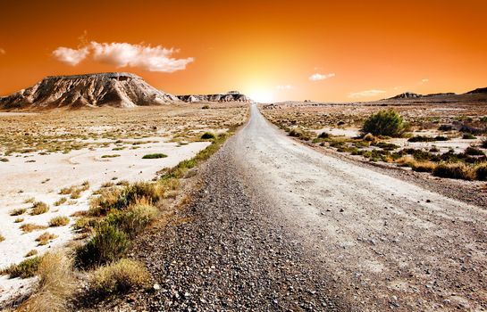 Sunset desert landscape with road