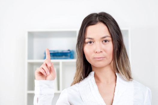 portrait of a beautiful woman, points her finger up