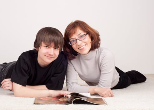 mother and son are together and smile in studio