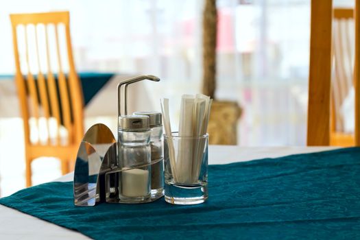 table in a cafe with salt pepper and toothpicks as background