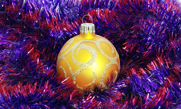 Yellow christmas toy on tinsel