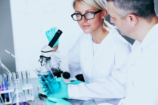  two scientist in chemical lab conducting experiments