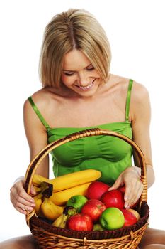 woman holds a basket of fruit on a white background