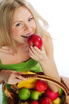 woman holds a basket of fruit on a white background