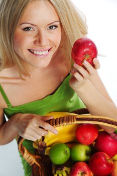 woman holds a basket of fruit on a white background