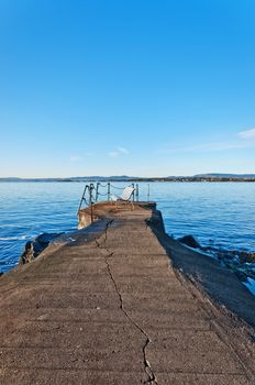 Bench on pier on a waters of Norwegian Sea