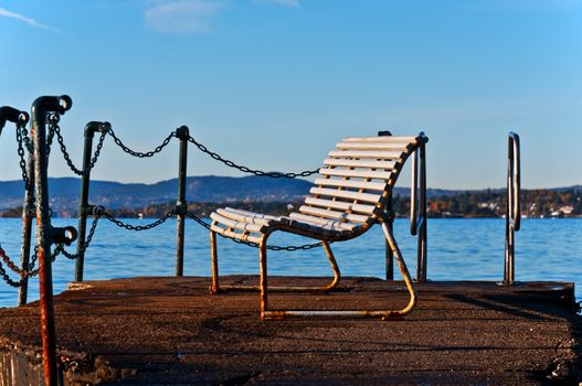 Bench on water of north sea Oslo Norway