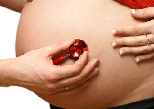 A doctor does a routine checkup on the expecting mother.