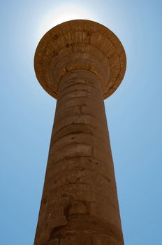 Stone ancient column with sun behind  in Karnak Temple, luxor,Egypt