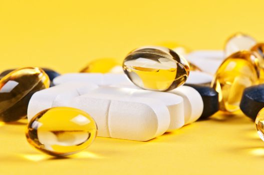 Macro pills over yellow background