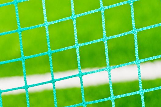 Football  goal mesh on the field background