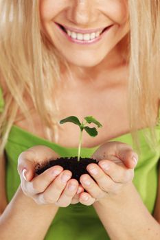 plant in blonde hands close up