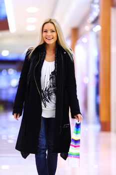 woman in shop center holds the bag in hands