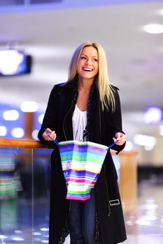 woman in shop center holds the bag in hands