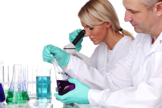 two scientist in chemical lab conducting experiments