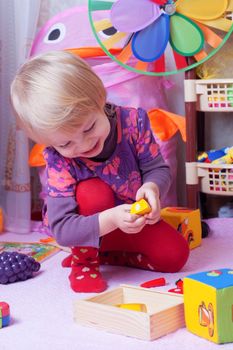 Little girl in playing room with toys