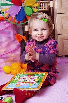Little girl in playing room with puzzle