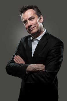 Handsome Smiling Middle Age Business Man Arms Folded Grey Background High Contrast Grunge Look