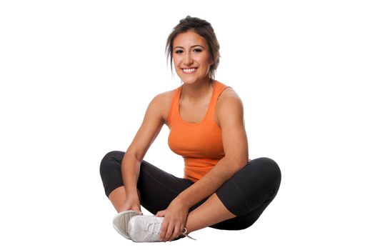 Beautiful happy smiling young woman doing fitness exercise for good health sitting, isolated.