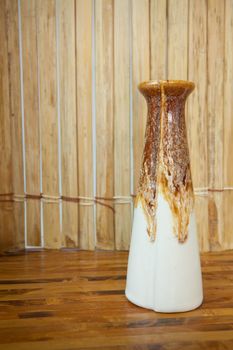 Brown vase on the old wood background