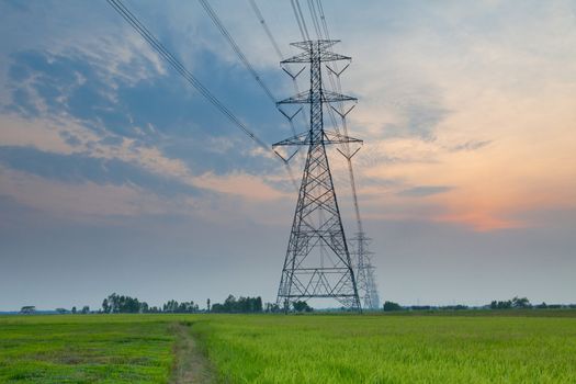 Electric power station in the field on sunset