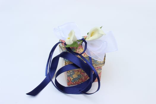 image of fine colored gift box with flowers and bow