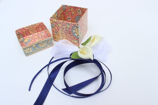 opened gift box with decorative ribbon and flowers