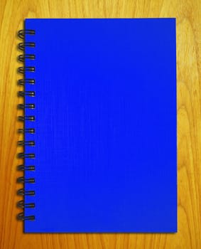 blue notebook on wood background