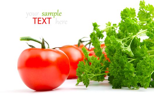 Red tomato with parsley isolated on white background.
