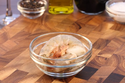 raw fresh prawns with ingredients  on background over fancy cutting board shallow dof  