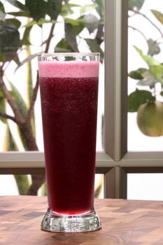 Glass of delicious organic and fresh concord grape juice full of antioxidants and nutrients 