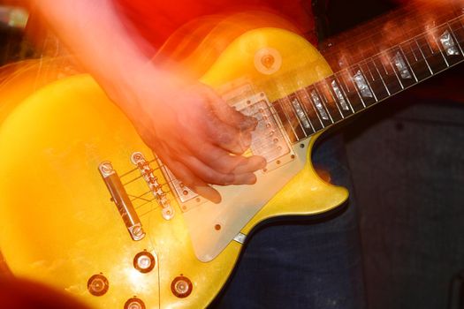 closeup of an guitarist at a rock concert, motioneffect!
